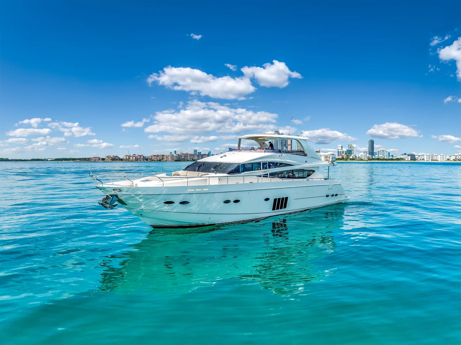 88' Princess flybridge yacht cruising Biscayne Bay on a Miami corporate yacht charter