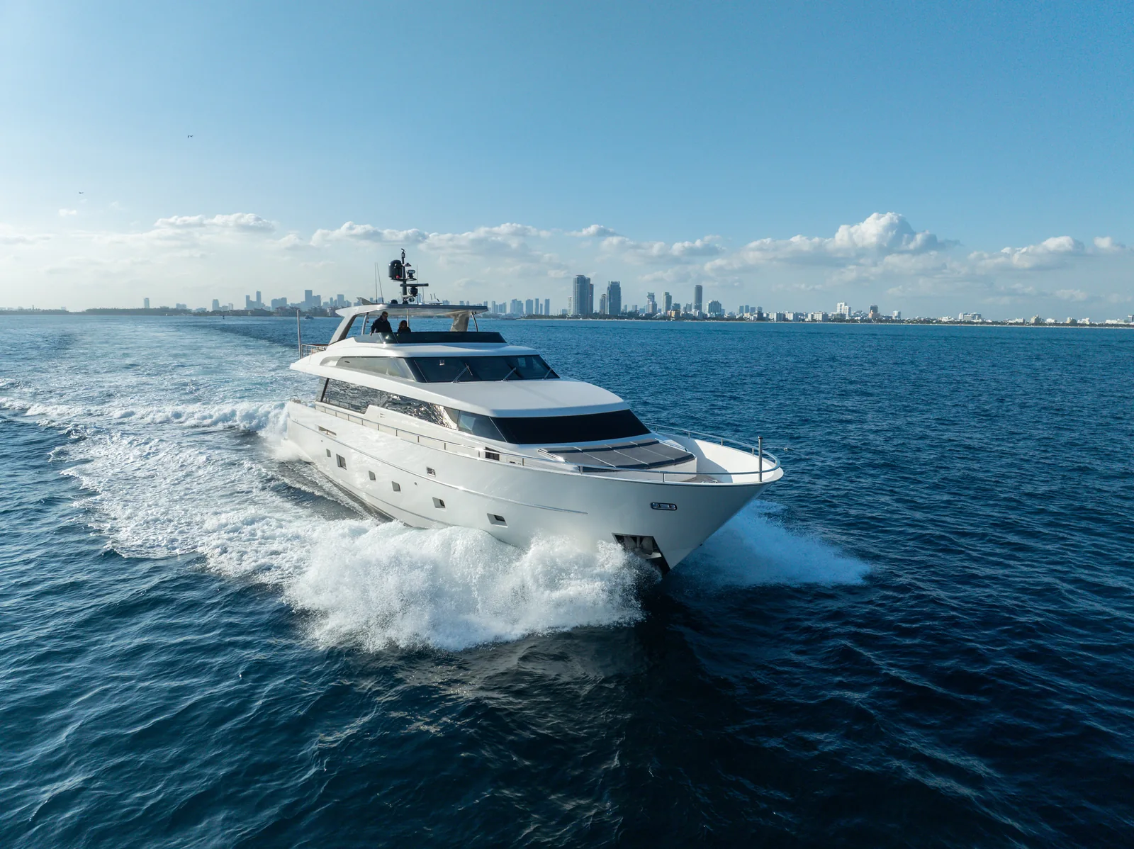 97' San Lorenzo luxury yacht cruising past the downtown Miami skyline