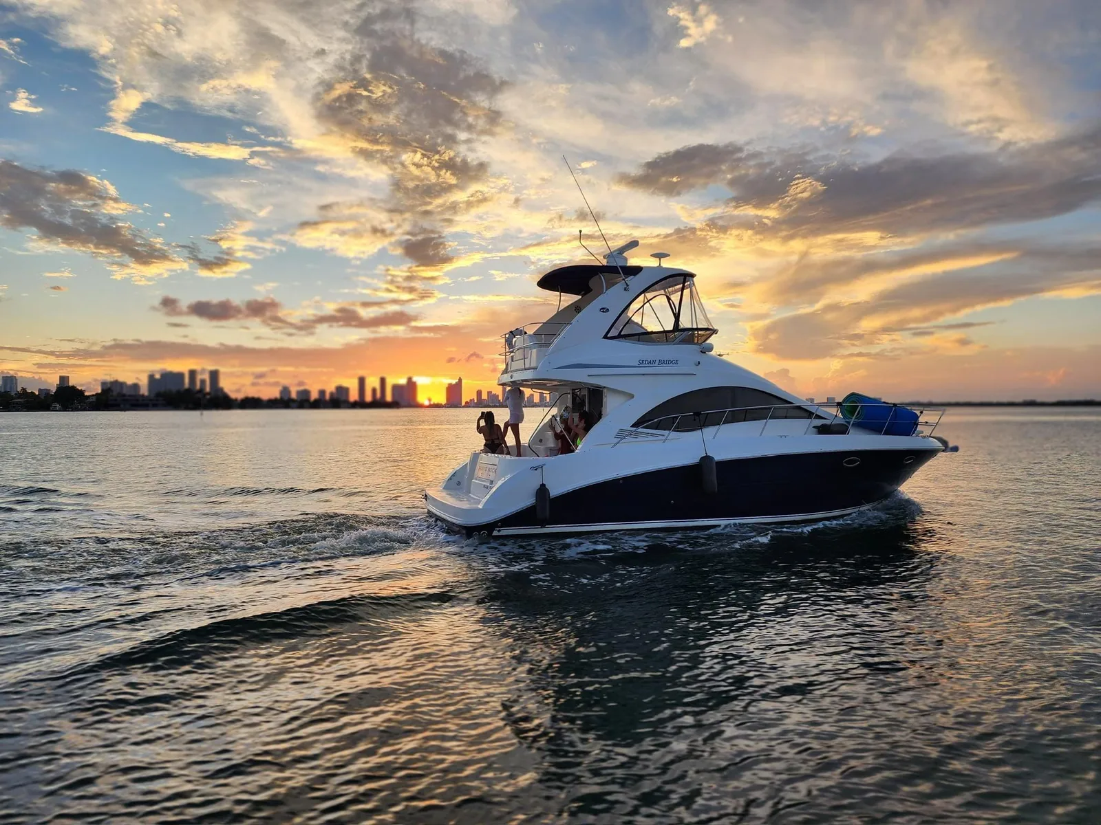 40' Sea Ray Sedan party yacht charter at sunset with the Miami skyline on Biscayne Bay