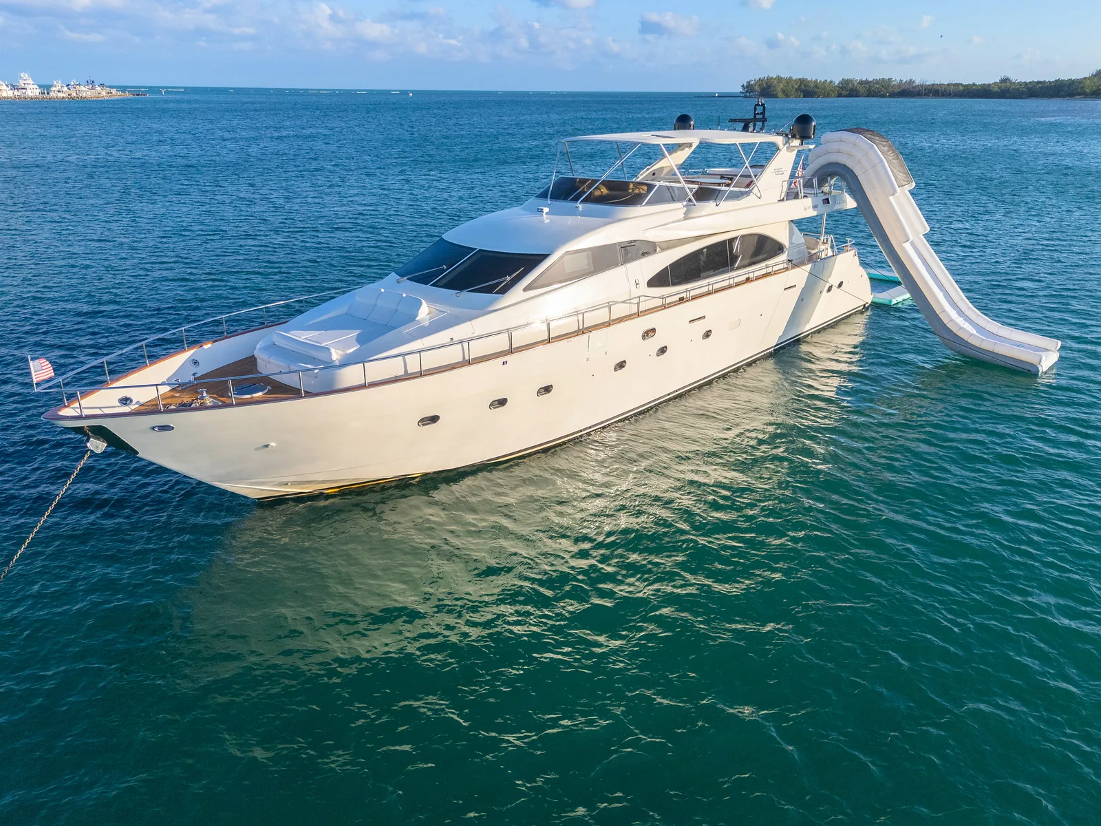 White luxury yacht anchored in turquoise water for a romantic Miami charter